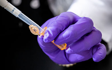 Woman in front of lab equipment