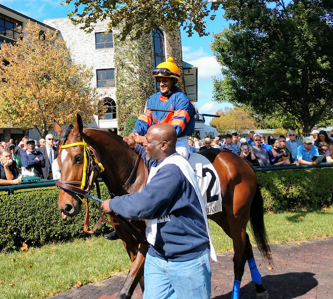 War Eagle's Love in the paddock with jockey and groom.