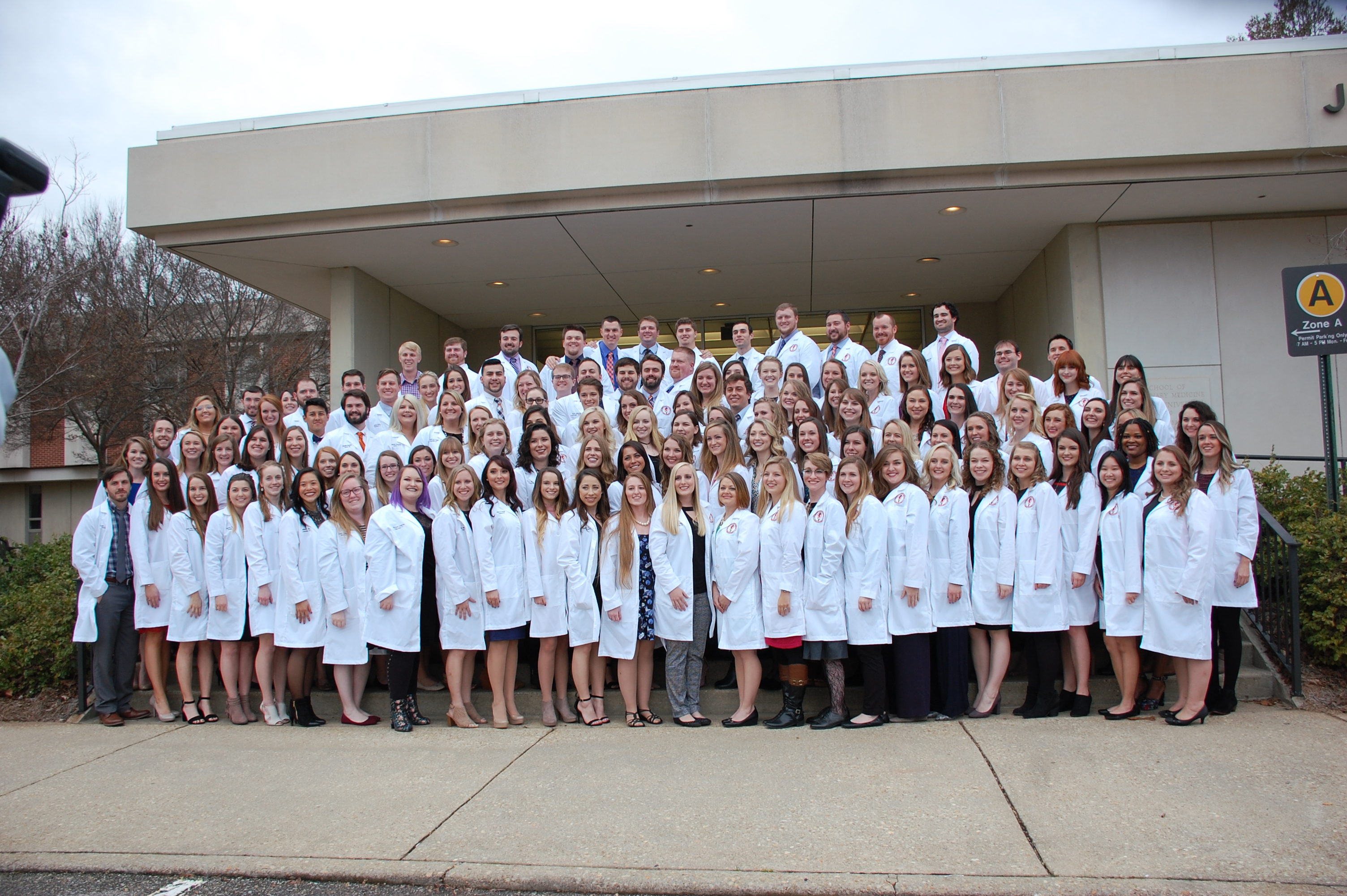 Members of the class of 2019 pose for a group photo after receiving their white coats in 2018.