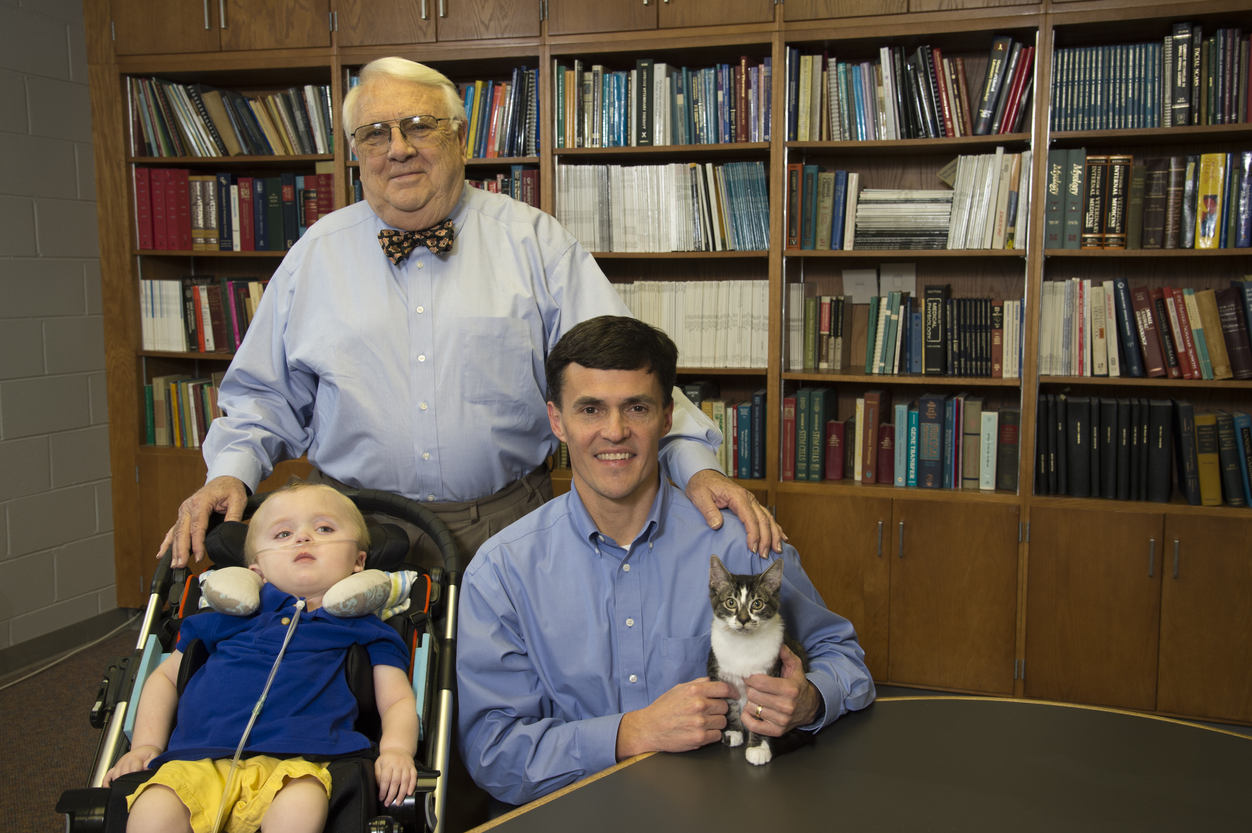 Dr. Henry Baker, standing, director emeritus of the Scott-Ritchey Research Center who played a pivotal role in early GM1 research, with Porter Heatherly, Dr. Doug Martin and one of the GM1 cats.