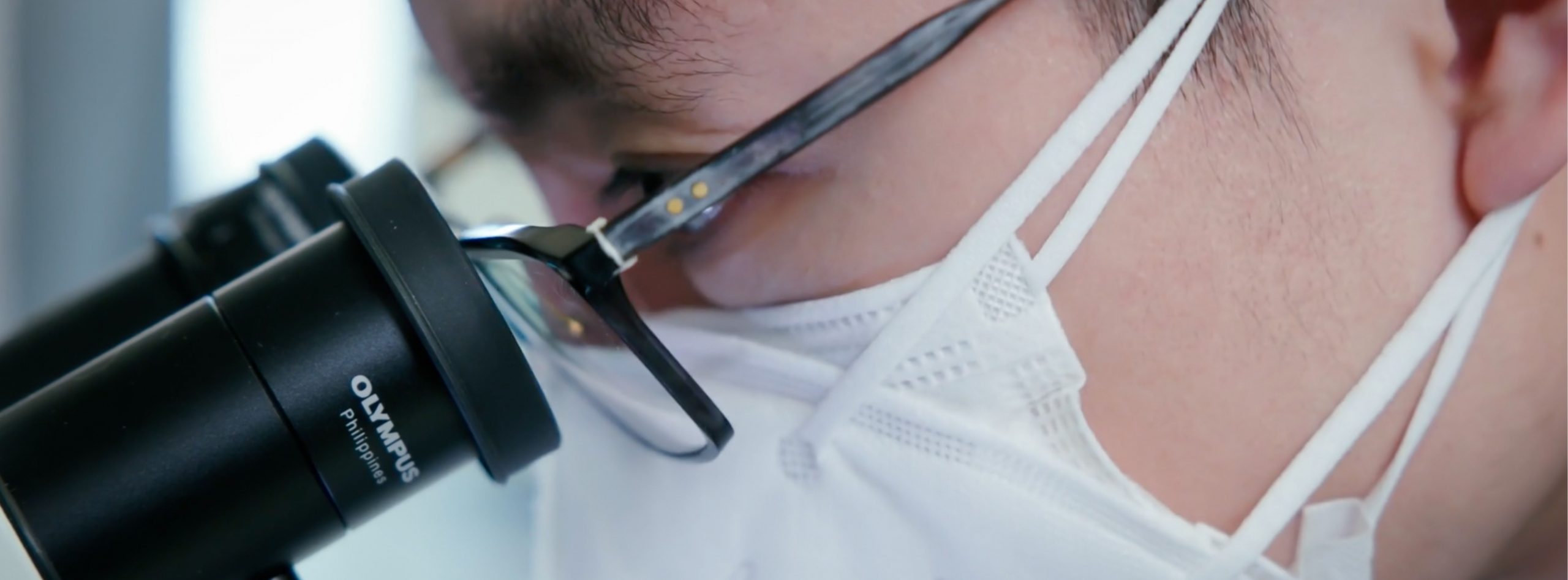 Student looking into microscope